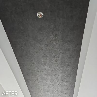 Vaulted ceiling hung with a gray textured wallcovering