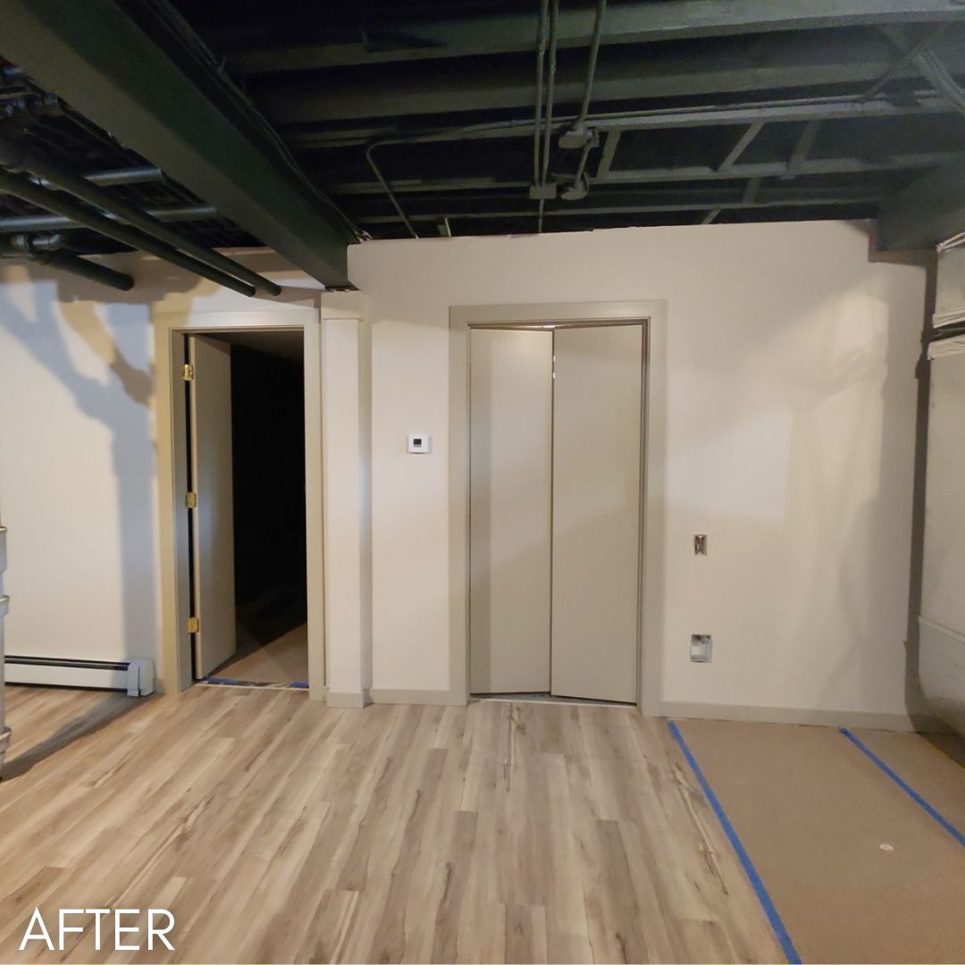 Office fit-out after painting, cream walls below an exposed services ceiling