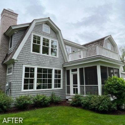 Shingled house in gray with white trim and a screened porch