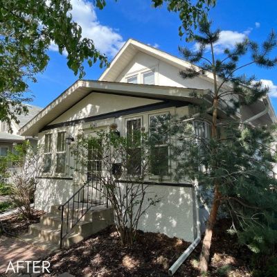 Bungalow in pale sage with a flat canopy over the entrance