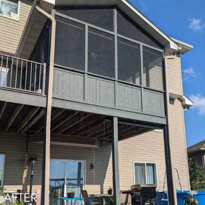 Screened porch and balcony in tan siding on a walkout elevation