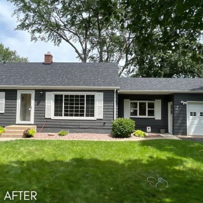 Rambler in slate blue siding with white window trim