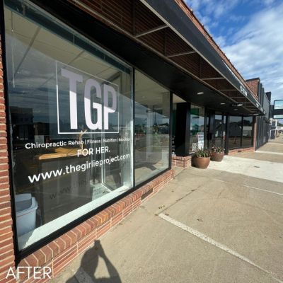 Shopfront windows lettered for a chiropractic and fitness studio