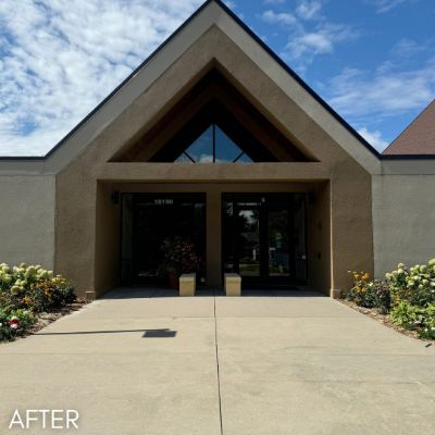 Church entrance with a timber-framed gable above glazed doors