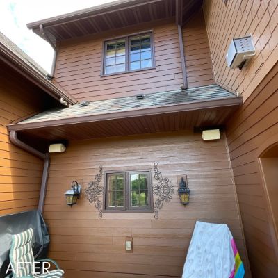 Stained cedar siding and soffit around an upper window