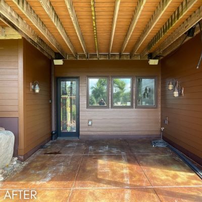 Covered patio lined in stained cedar, with a stamped concrete floor