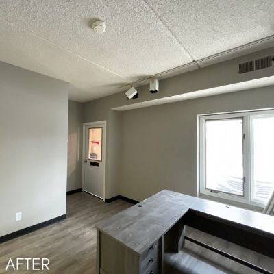 Office interior after painting, warm gray walls beside a glazed door