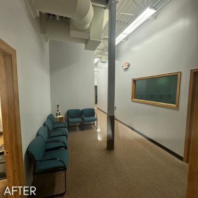 Clinic waiting room after painting, sage walls above teal seating