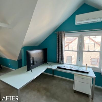Attic office after painting, teal walls below a sloped white ceiling