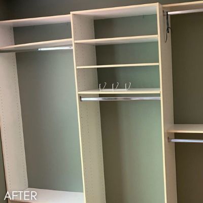 Walk-in closet shelving enameled, against sage green walls