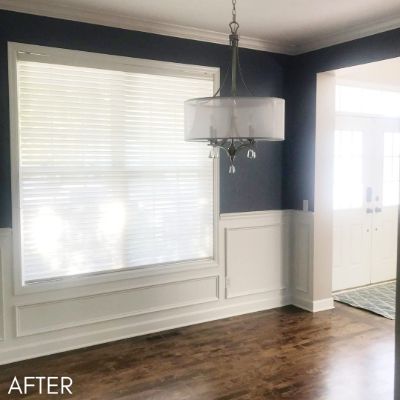 Dining room after painting, navy walls above white panelled wainscoting