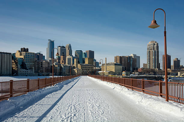 The Minneapolis skyline seen along the Stone Arch Bridge in winter snow