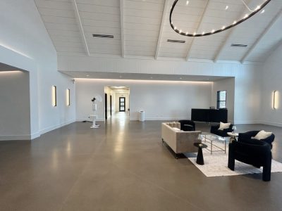 Event venue lobby with white walls, vaulted white ceiling and polished concrete floor